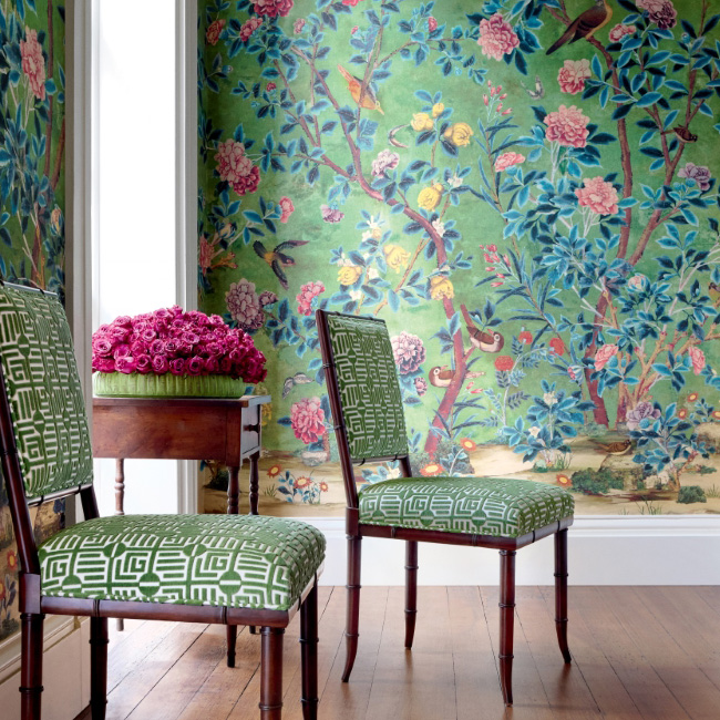 chairs and a table in front of walls with fantastic wallpaper