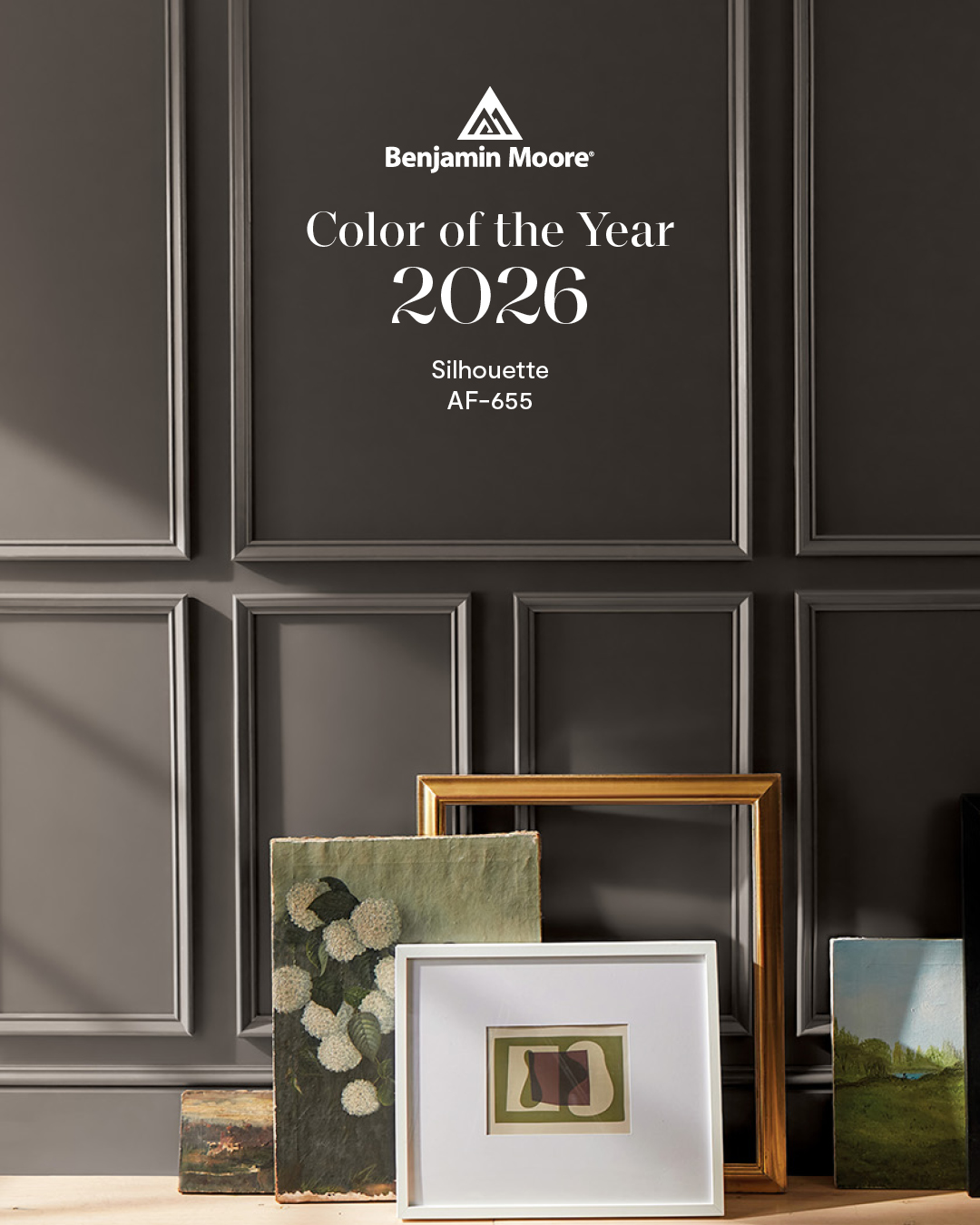 Wall with pictures leaning against it. Shows the Benjamin Moore Color of the Year